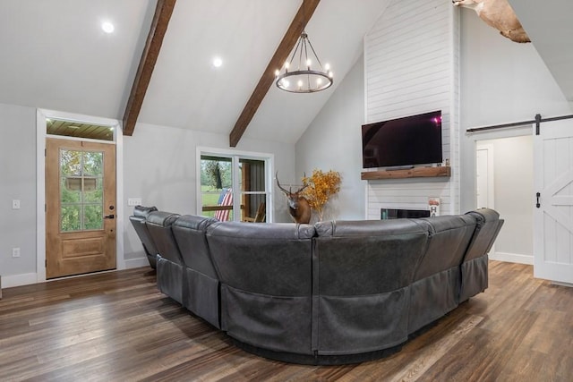 living room featuring dark hardwood / wood-style floors, a barn door, a fireplace, and high vaulted ceiling