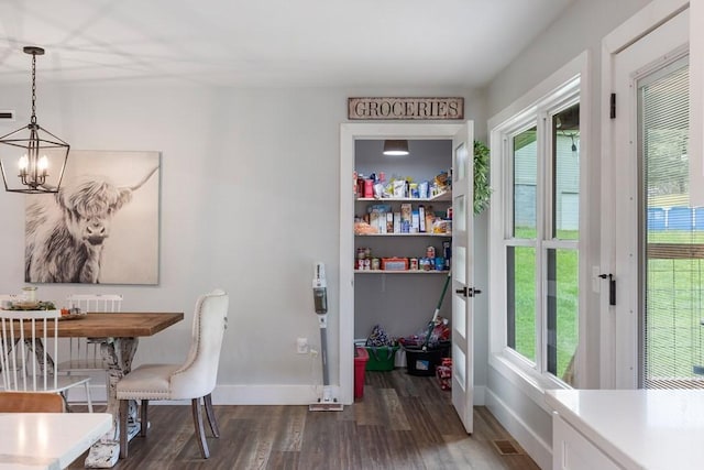 dining room featuring plenty of natural light, a chandelier, and dark hardwood / wood-style floors