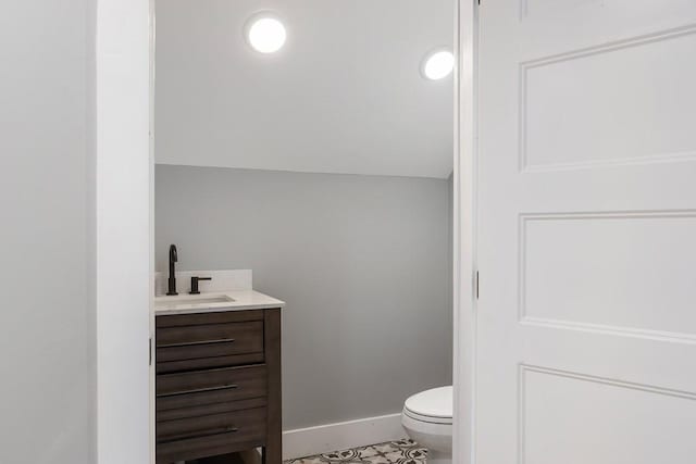 bathroom with tile patterned floors, vanity, and toilet