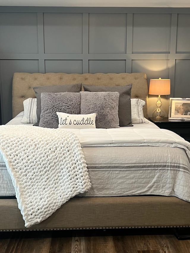 bedroom with dark hardwood / wood-style flooring