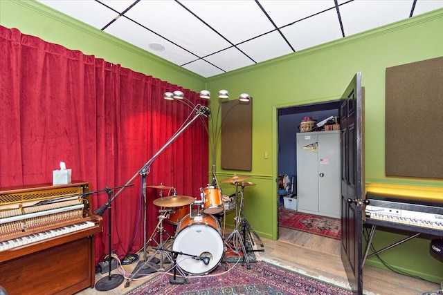 miscellaneous room featuring wood-type flooring and crown molding