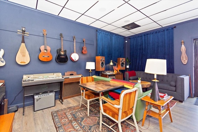 playroom with a paneled ceiling and hardwood / wood-style flooring