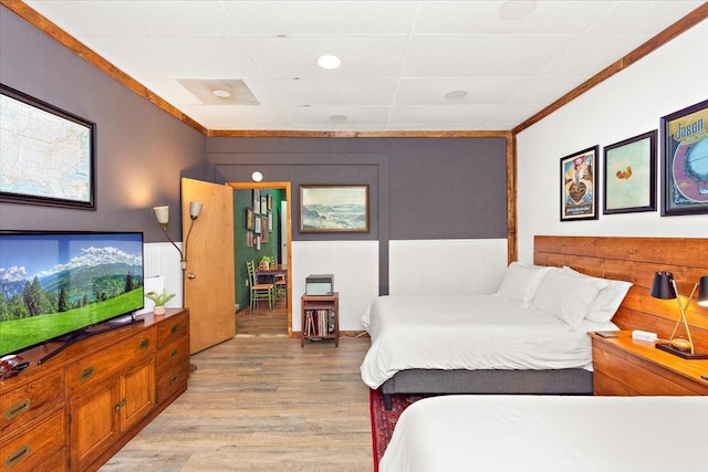 bedroom featuring light hardwood / wood-style floors and ornamental molding