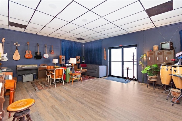 interior space featuring wood-type flooring and a paneled ceiling