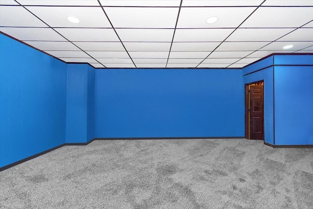 unfurnished room featuring carpet flooring and a paneled ceiling