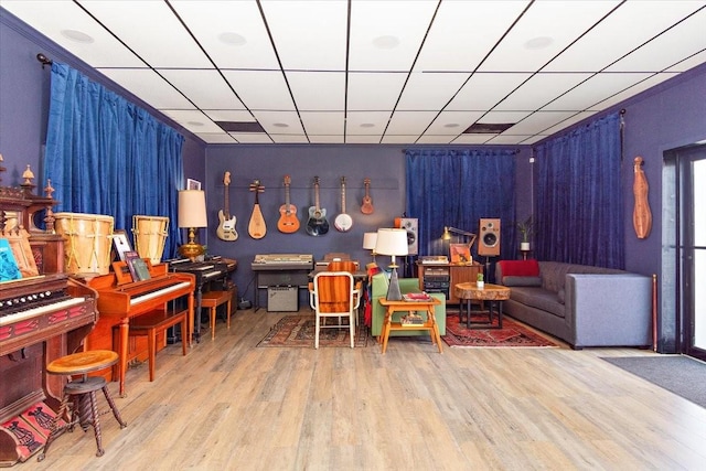 interior space with light hardwood / wood-style flooring and a drop ceiling