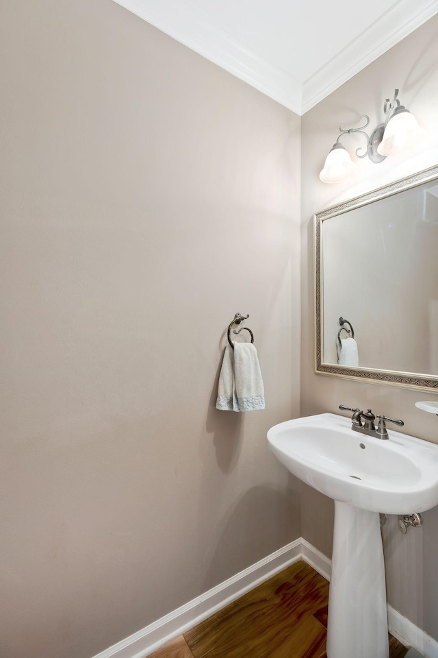 bathroom with wood-type flooring and crown molding