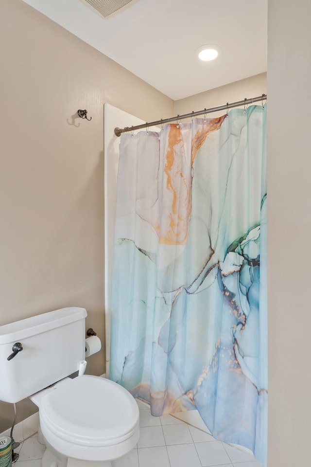 bathroom featuring tile patterned flooring and toilet