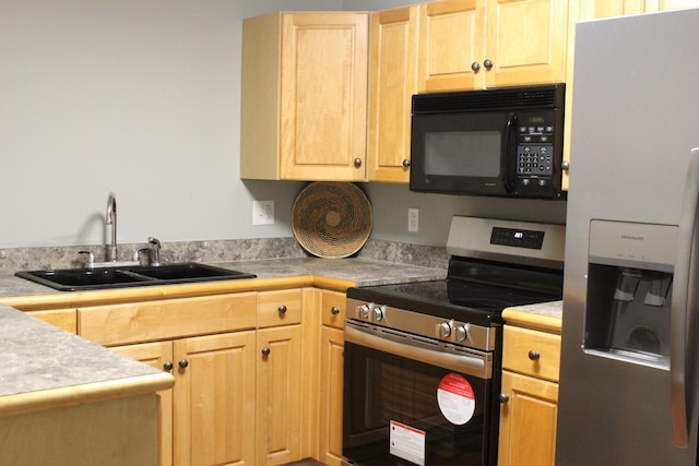 kitchen with light brown cabinetry, sink, and appliances with stainless steel finishes