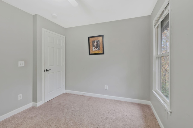 carpeted empty room with a wealth of natural light