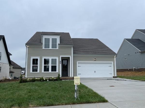 view of front of property featuring a front lawn and a garage