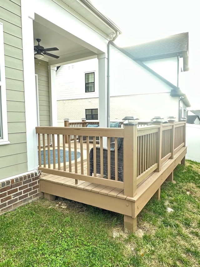 deck with ceiling fan and a swimming pool