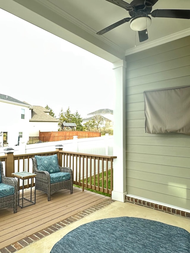 wooden balcony with a deck and ceiling fan