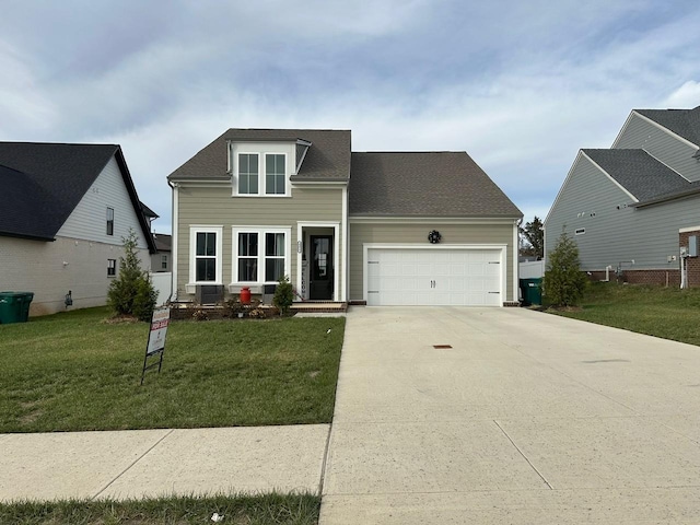 view of front of house featuring a garage and a front lawn