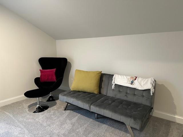 sitting room with carpet and lofted ceiling