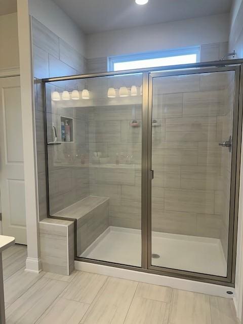 bathroom with a shower stall and vanity