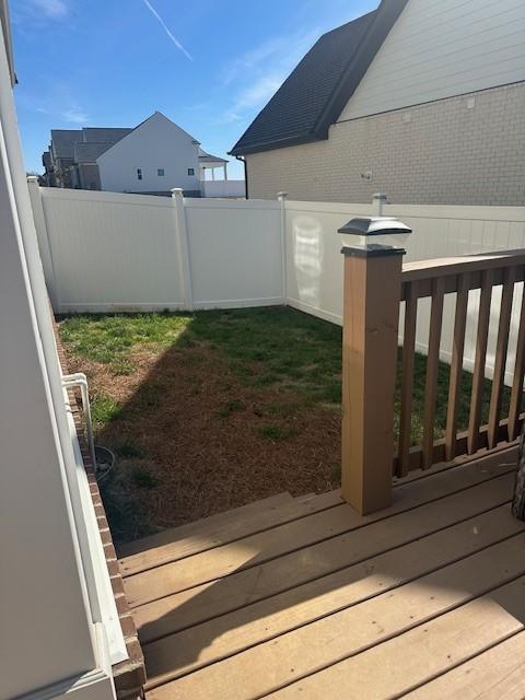 view of yard featuring a fenced backyard and a wooden deck