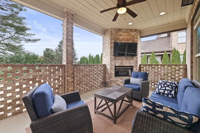 view of patio featuring an outdoor living space with a fireplace and ceiling fan