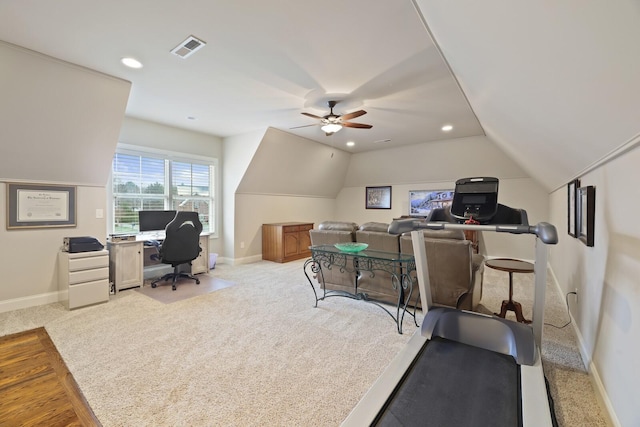 carpeted office space with ceiling fan and vaulted ceiling