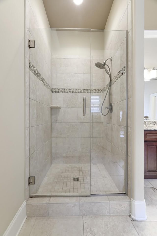 bathroom with vanity and a shower with door