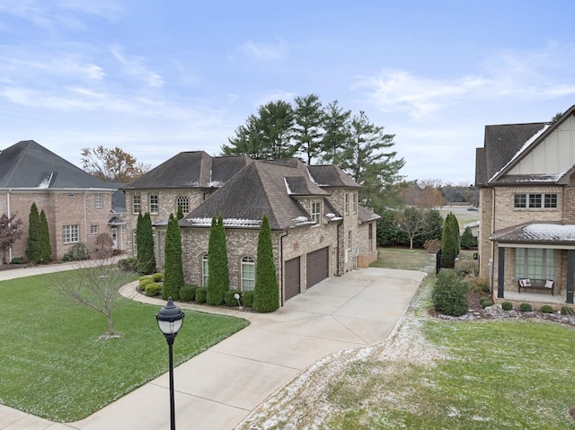 view of side of property featuring a yard and a garage