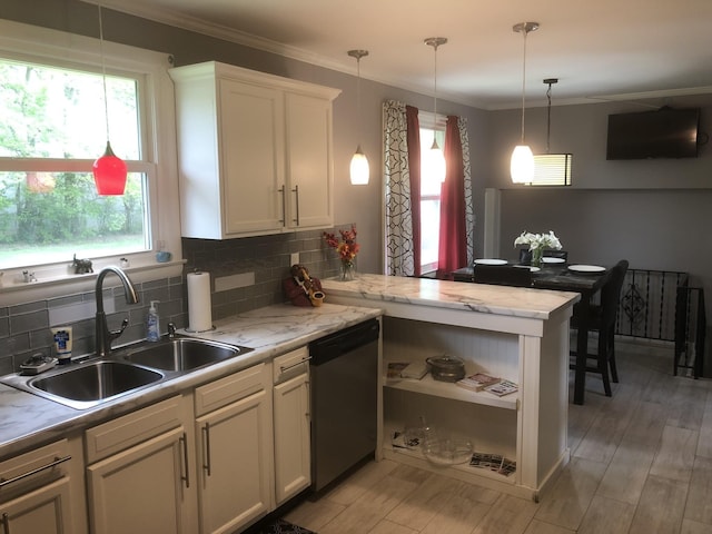 kitchen featuring kitchen peninsula, light hardwood / wood-style flooring, stainless steel dishwasher, and a healthy amount of sunlight