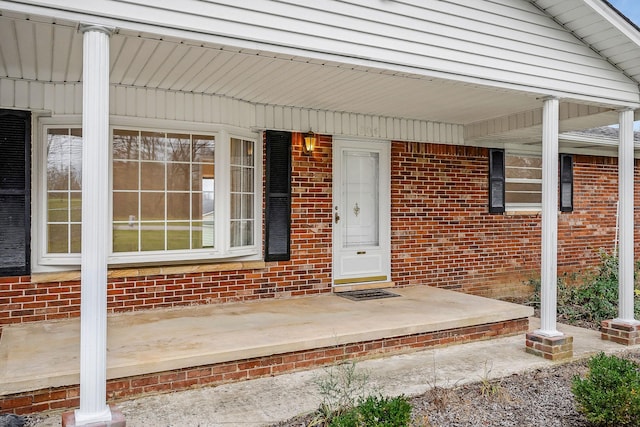 view of exterior entry with a porch