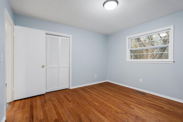 unfurnished bedroom featuring a closet and wood-type flooring