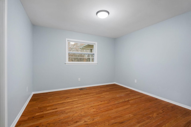 unfurnished room with hardwood / wood-style floors