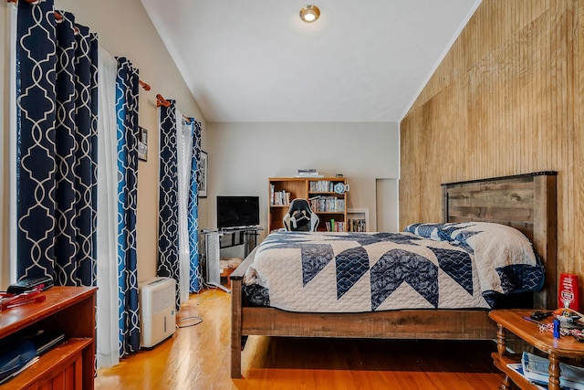 bedroom featuring lofted ceiling and hardwood / wood-style flooring