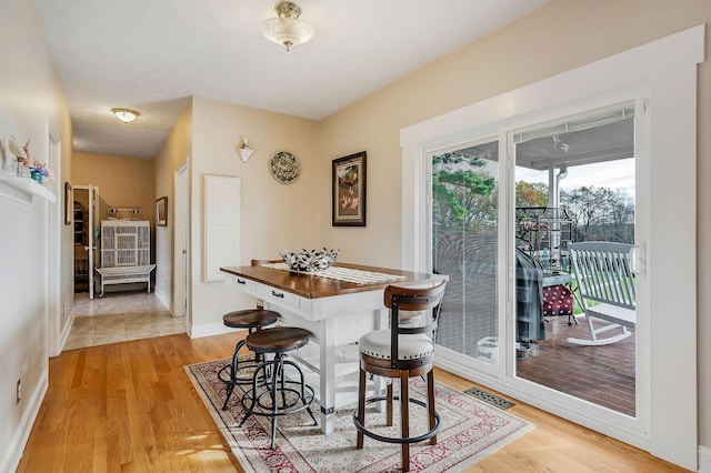 dining space with light wood-type flooring