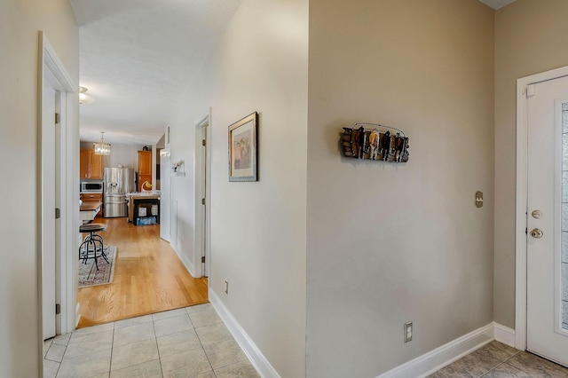 entrance foyer featuring a notable chandelier and light hardwood / wood-style flooring