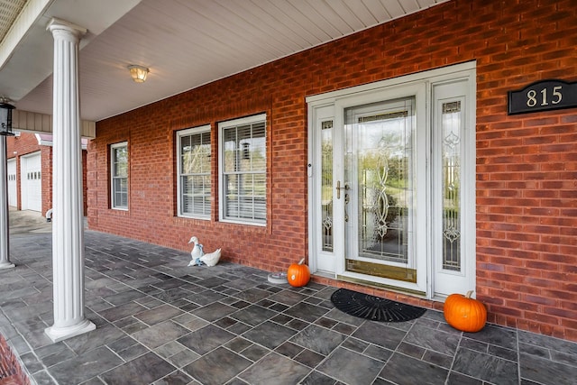 view of exterior entry with covered porch