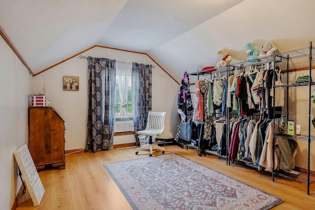 walk in closet featuring hardwood / wood-style floors and lofted ceiling