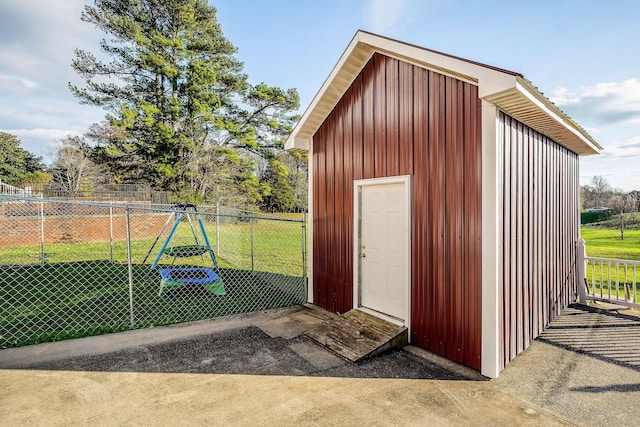 view of outbuilding with a lawn and a playground