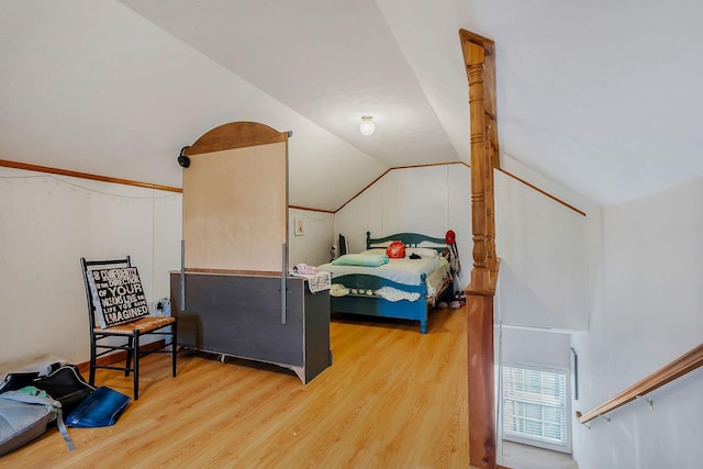 bedroom featuring light hardwood / wood-style floors and lofted ceiling