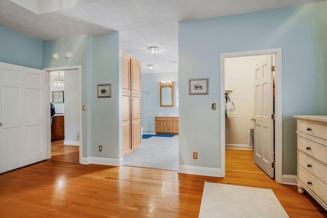 hallway with light hardwood / wood-style floors