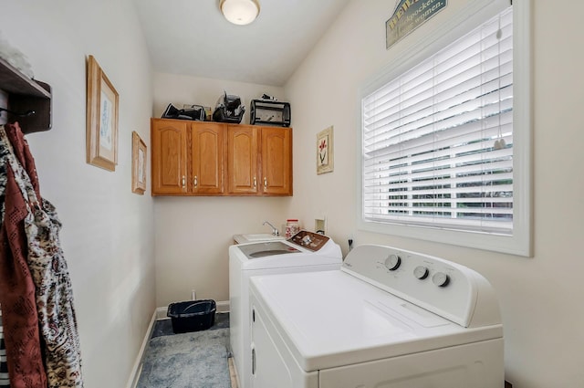 laundry area with cabinets, washing machine and dryer, and sink