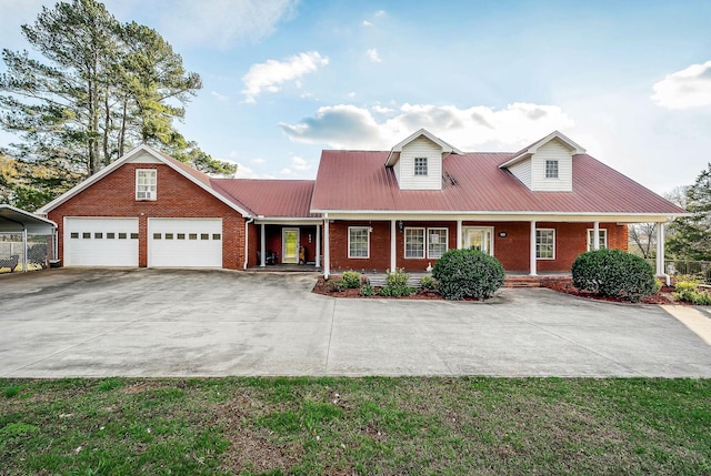 cape cod-style house with covered porch, a carport, and a front yard