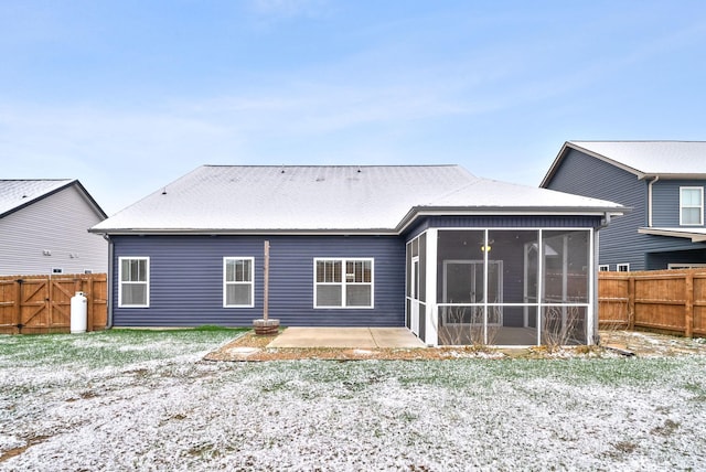 rear view of property with a patio and a sunroom