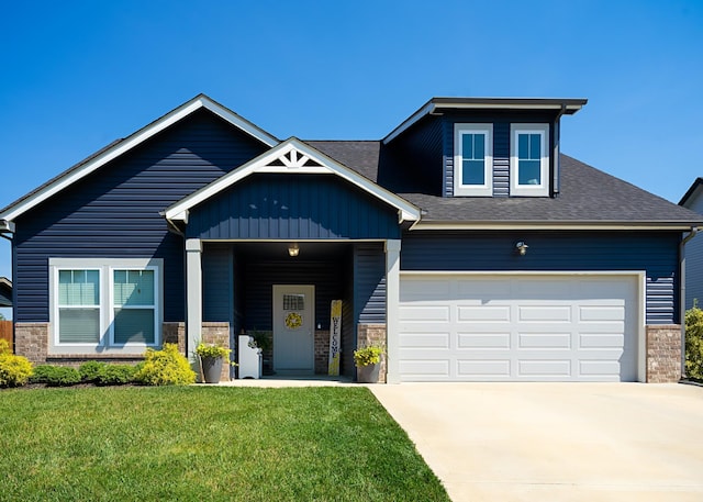 craftsman-style house featuring a garage and a front lawn