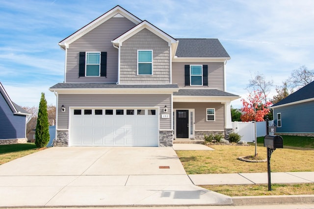 view of front of home with a garage and a front lawn