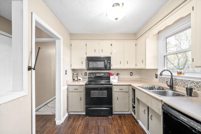 kitchen with dark hardwood / wood-style flooring, black appliances, a textured ceiling, and sink