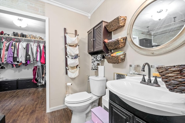 bathroom featuring hardwood / wood-style floors, vanity, a shower, crown molding, and toilet