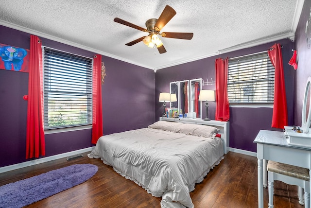 bedroom featuring ceiling fan, crown molding, dark wood-type flooring, and multiple windows