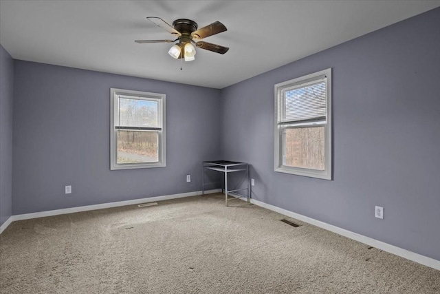 carpeted empty room featuring ceiling fan