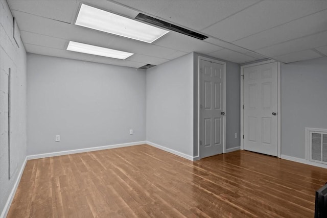 basement with hardwood / wood-style flooring