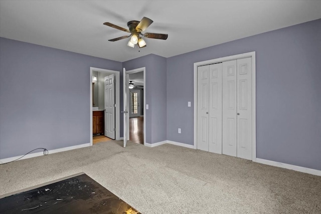 unfurnished bedroom featuring connected bathroom, ceiling fan, a closet, and light colored carpet