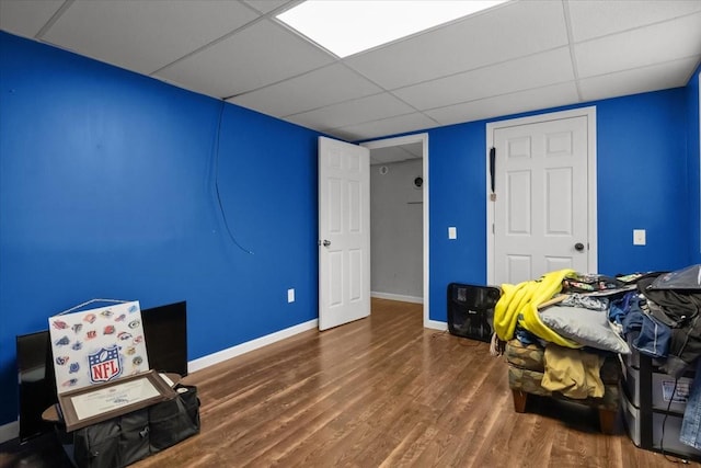 interior space with hardwood / wood-style floors and a drop ceiling