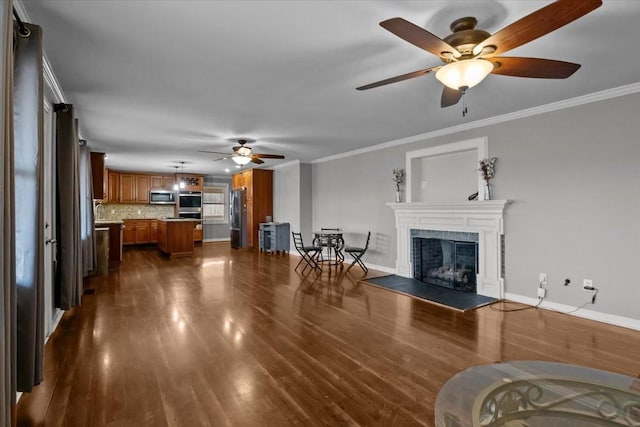 living room with dark hardwood / wood-style flooring, ceiling fan, and ornamental molding